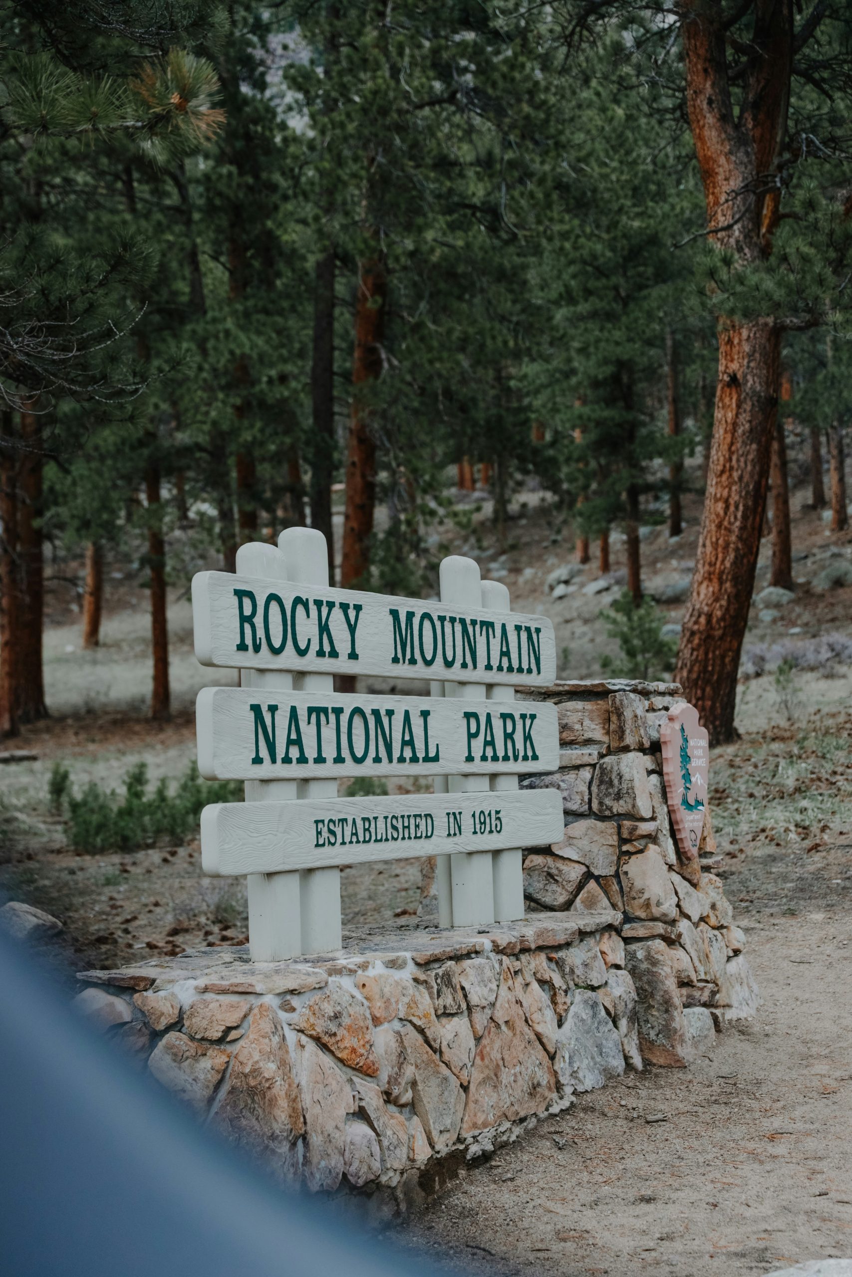 Entrance sign to Rocky Mountain National Park, welcoming visitors to the natural beauty and adventures ahead.